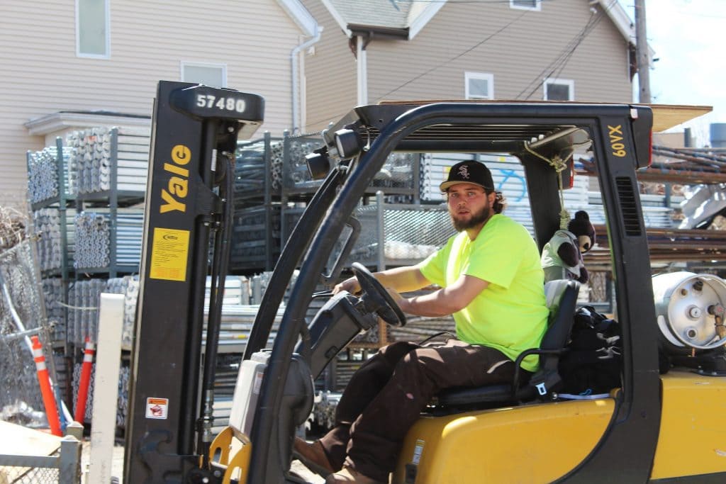 A forklift operator at a scaffolding site.